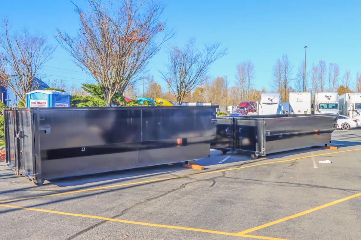 Professional dumpster rental service with roll-off container on residential driveway in Burlington